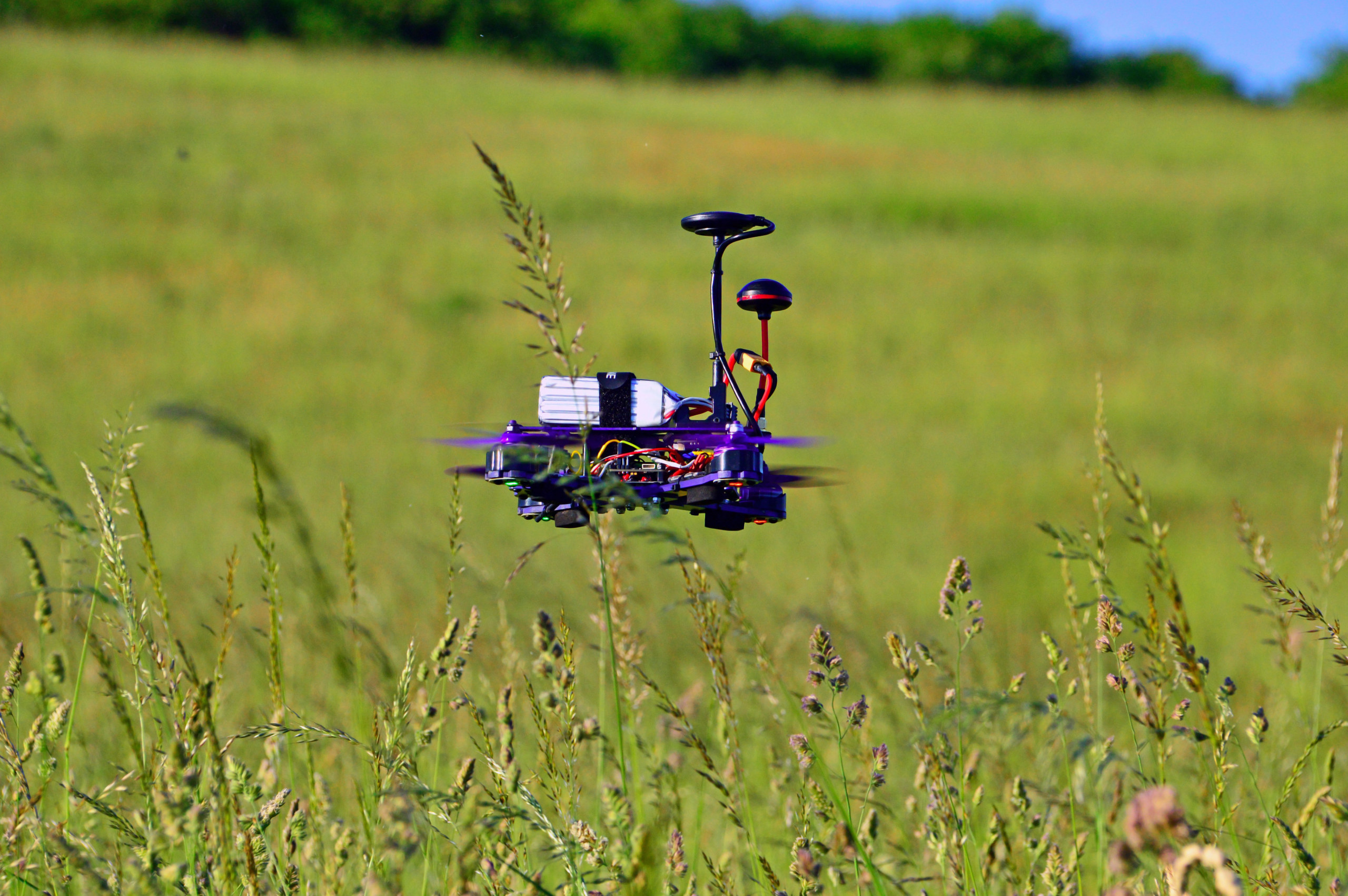 5-inch long-range FPV drone hovering over a meadow